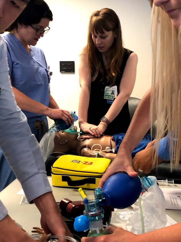 Doctors and residents performing simulated CPR training